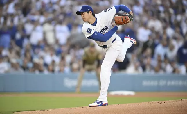 Los Angeles Dodgers starting pitcher Shohei Ohtani warms up on the mound before a baseball game against the San Diego Padres, Monday, June 16, 2025, in Los Angeles. (AP Photo/Kyusung Gong)