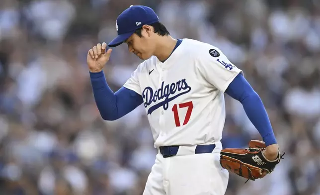 Los Angeles Dodgers starting pitcher Shohei Ohtani prepares to pitch during the first inning of a baseball game against the San Diego Padres, Monday, June 16, 2025, in Los Angeles. (AP Photo/Kyusung Gong)