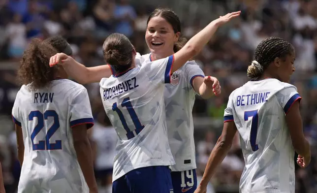 United States midfielder Izzy Rodriguez (11) celebrates after scoring with forward Emma Sears (19) during the first half of an international friendly women's soccer match against Ireland in Cincinnati, Sunday, June 29, 2025. (AP Photo/Carolyn Kaster)