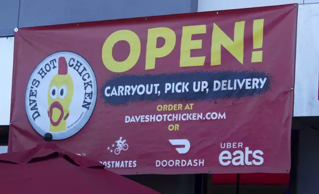 An open sign for Dave's Hot Chicken restaurant is seen in the Little Tokyo district of Los Angeles Monday, June 2, 2025. (AP Photo/Damian Dovarganes)
