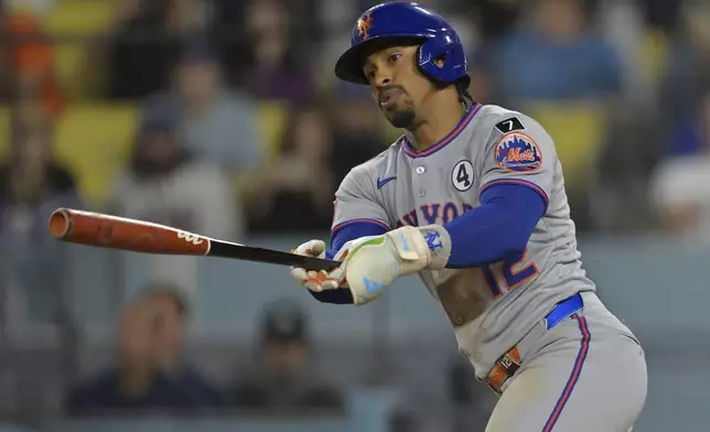 New York Mets' Francisco Lindor singles in a run in the tenth inning of a baseball game against the Los Angeles Dodgers, Monday, June 2, 2025, in Los Angeles. (AP Photo/Jayne Kamin-Oncea)