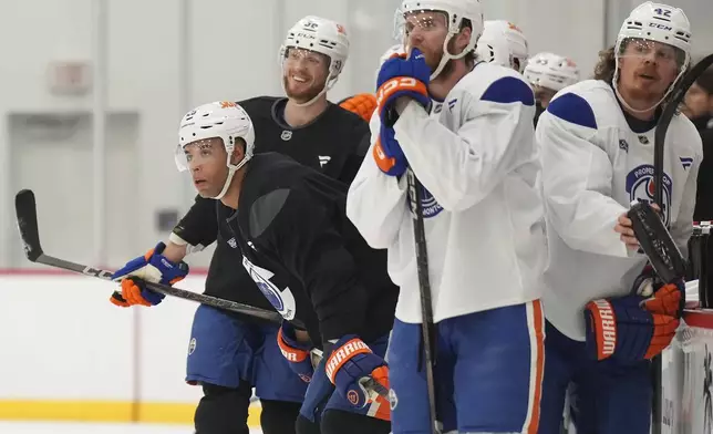 Edmonton Oilers defenceman Darnell Nurse, left, looks up ice during practice at the NHL Stanley Cup Finals in Fort Lauderdale, Fla., Tuesday, June 10, 2025.(Nathan Denette/The Canadian Press via AP)