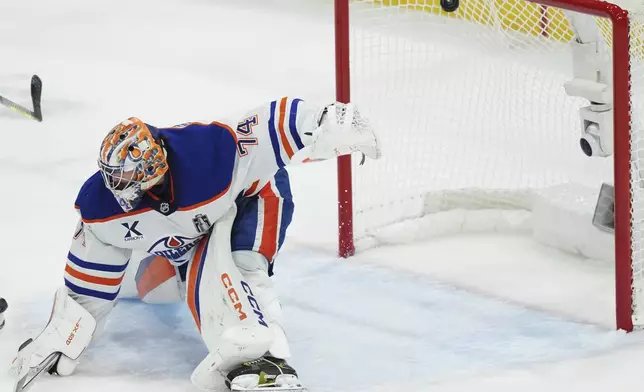Edmonton Oilers goalie Stuart Skinner (74) is scored on by Florida Panthers' Sam Bennett, not shown, during the second period in Game 3 of the NHL hockey Stanley Cup finals in Sunrise, Fla., Monday, June 9, 2025. (Nathan Denette/The Canadian Press via AP)