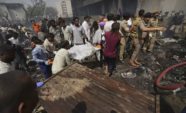 Rescuers work at the site of an airplane that crashed in India's northwestern city of Ahmedabad in Gujarat state, Thursday, June 12, 2025. (AP Photo/Ajit Solanki)