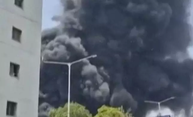 Smoke rises after an airplane crashed in Ahmedabad, Gujarat state, India, Thursday, June 12, 2025. (Mohan Nakum via AP)