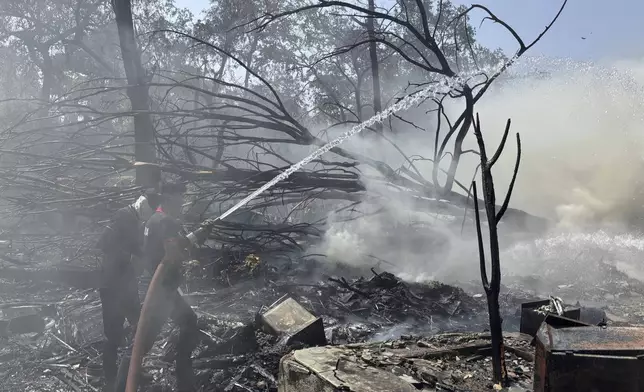 Rescuers work at the site of an airplane that crashed in India's northwestern city of Ahmedabad in Gujarat state, Thursday, June12, 2025. (AP Photo/Ajit Solanki)