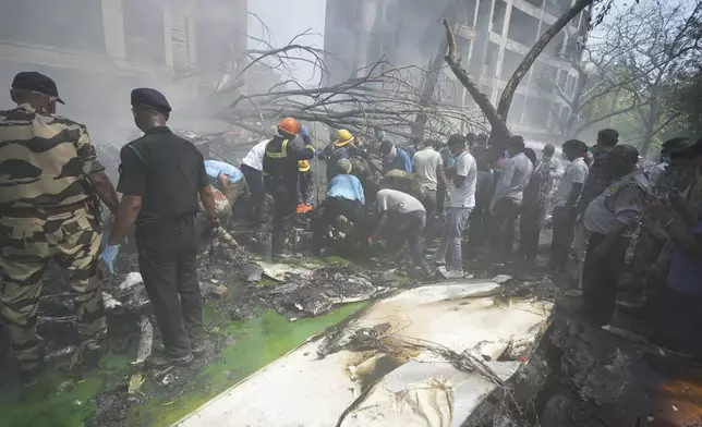 Rescuers work at the site of an airplane that crashed in India's northwestern city of Ahmedabad in Gujarat state, Thursday, June 12, 2025. (AP Photo/Ajit Solanki)