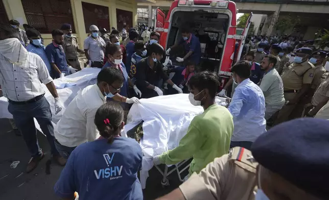 Remains of victims are brought to Civil Hospital after an airplane crashed in India's northwestern city of Ahmedabad in Gujarat state, Thursday, June 12, 2025. (AP Photo/Ajit Solanki)