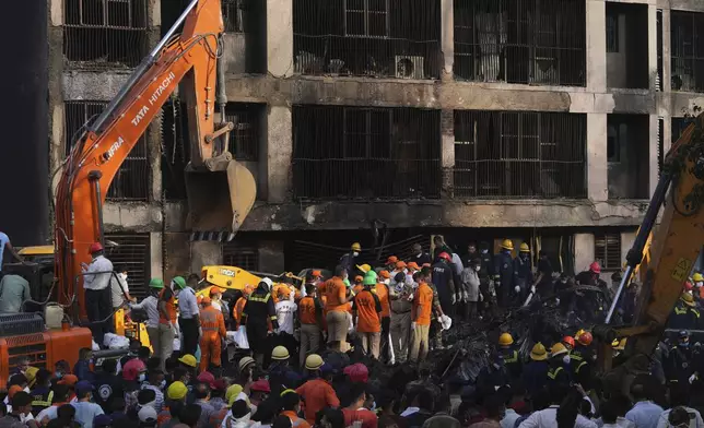 Search and rescue teams respond to the scene of a plane crash in Ahmedabad, India, Thursday, June 12, 2025. (AP Photo/Ajit Solanki)