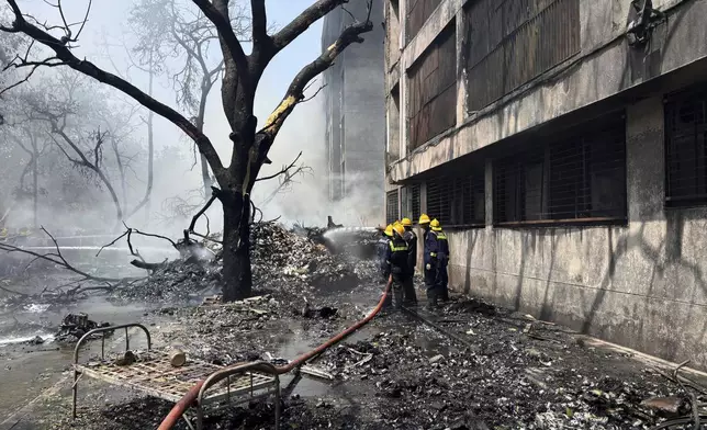 Firefighters work at the site of an airplane that crashed in India's northwestern city of Ahmedabad in Gujarat state, Thursday, June12, 2025. (AP Photo/Ajit Solanki)