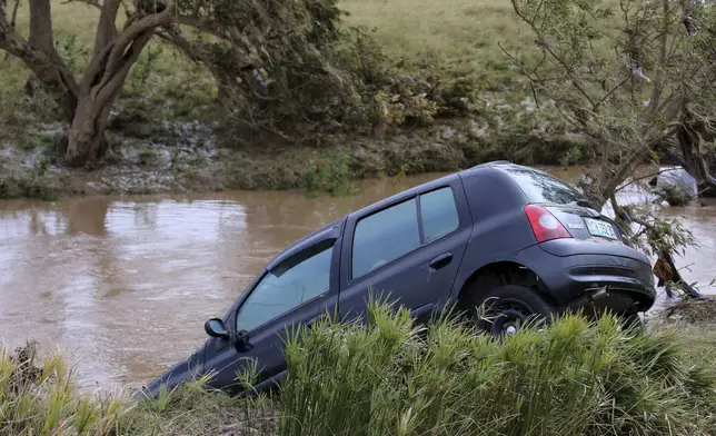 A view of a vehicle abandoned in a flooded area, in Mthatha, South Africa, Wednesday, June 11, 2025. (AP Photo/Hoseya Jubase)