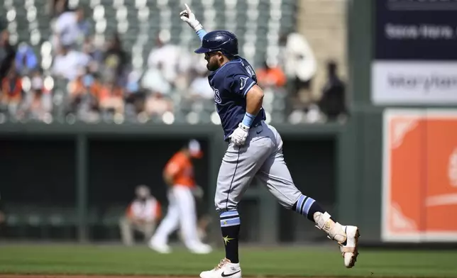 Tampa Bay Rays' Jonathan Aranda celebrates his two-run home run as he rounds the bases during the first inning of a baseball game against the Baltimore Orioles, Saturday, June 28, 2025, in Baltimore. (AP Photo/Nick Wass)