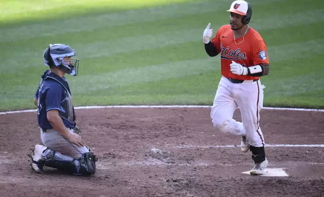 Baltimore Orioles' Chadwick Tromp, right, celebrates his home run during the fifth inning of a baseball game as Tampa Bay Rays catcher Matt Thaiss looks on at left, Saturday, June 28, 2025, in Baltimore. (AP Photo/Nick Wass)