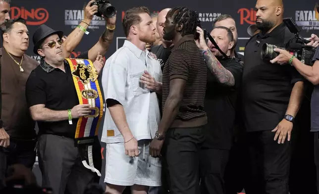 Canelo Alvarez, left, and Terence Crawford face off during a news conference for their upcoming boxing match Friday, June 27, 2025, in Las Vegas. (AP Photo/John Locher)