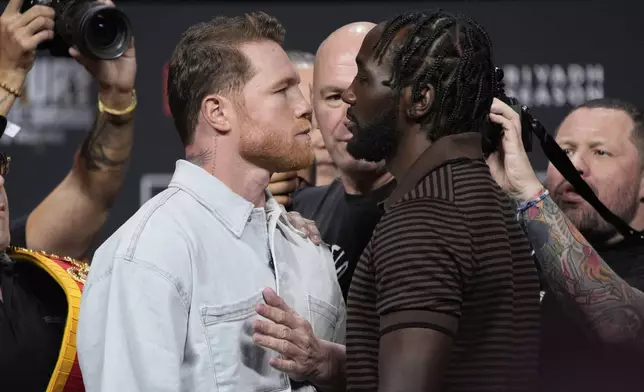 Canelo Alvarez, left, and Terence Crawford face off during a news conference for their upcoming boxing match Friday, June 27, 2025, in Las Vegas. (AP Photo/John Locher)