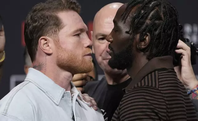 Canelo Alvarez, left, and Terence Crawford face off during a news conference for their upcoming boxing match Friday, June 27, 2025, in Las Vegas. (AP Photo/John Locher)