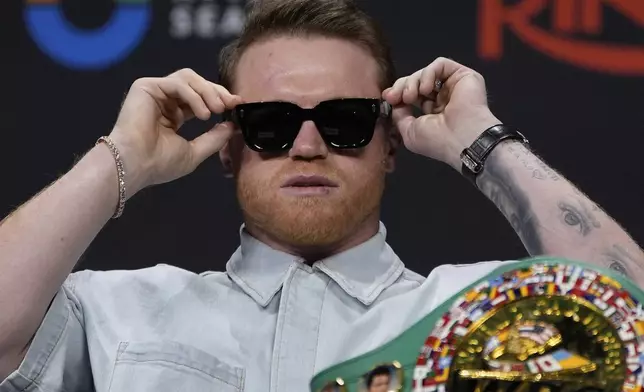 Canelo Alvarez adjusts his glasses during a news conference Friday, June 27, 2025, in Las Vegas. (AP Photo/John Locher)