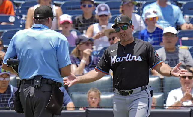 Miami Marlins manager Clayton McCullough, right, argues an interference call on Xavier Edwards with home plate umpire Chad Fairchild during the third inning of a baseball game against the Tampa Bay Rays Friday, June 6, 2025, in Tampa, Fla. (AP Photo/Chris O'Meara)