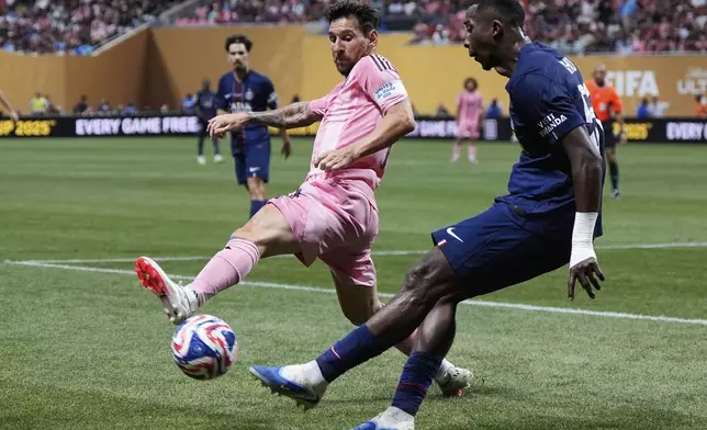 Inter Miami's Lionel Messi and Paris Saint-Germain's Willian Pacho compete for the ball during the Club World Cup round of 16 soccer match between PSG and Inter Miami in Atlanta, Sunday, June 29, 2025. (AP Photo/Mike Stewart)