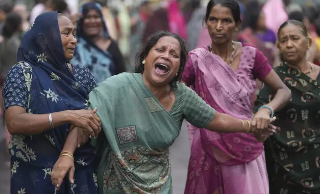 Relatives of Akash Patni, victim of the Air India plane crash, grieve during his funeral procession in Ahmedabad, India, Tuesday, June 17, 2025. (AP Photo/Ajit Solanki)