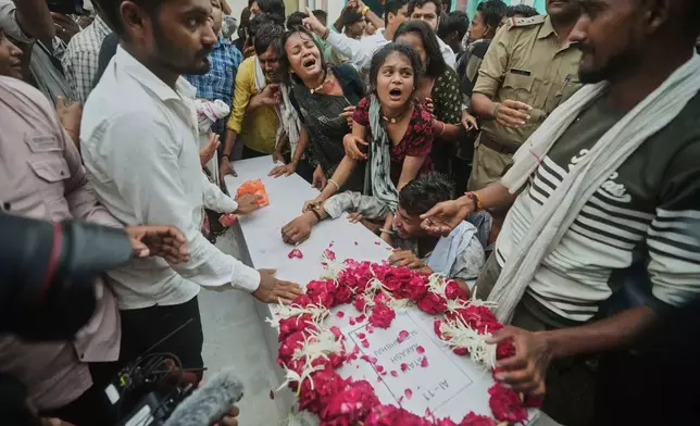 Family members and relatives of Akash Patni, victim of the Air India plane crash, grieve as his body arrives for funeral in Ahmedabad, India, Tuesday, June 17, 2025. (AP Photo/Ajit Solanki)