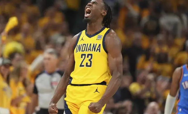 Indiana Pacers forward Aaron Nesmith reacts after a basket against the Oklahoma City Thunder during the first half of Game 4 of the NBA Finals basketball series, Friday, June 13, 2025, in Indianapolis. (AP Photo/Michael Conroy)