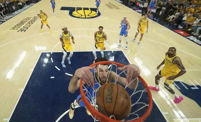 Oklahoma City Thunder forward Chet Holmgren (7) dunks against the Indiana Pacers during the first half of Game 3 of the NBA Finals basketball series, Wednesday, June 11, 2025, in Indianapolis. (AP Photo/Abbie Parr)