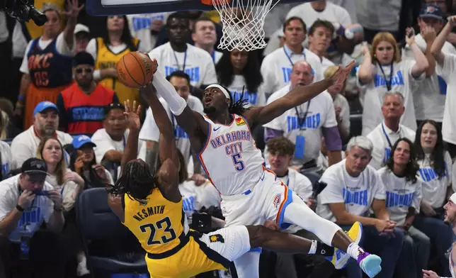 Oklahoma City Thunder guard Luguentz Dort (5) blocks a shot by Indiana Pacers forward Aaron Nesmith (23) during the second half of Game 1 of the NBA Finals basketball series Thursday, June 5, 2025, in Oklahoma City. (AP Photo/Nate Billings)