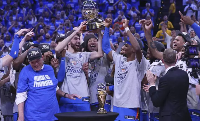 Oklahoma City Thunder players and coaches celebrate after Game 5 of the Western Conference finals of the NBA basketball playoffs against the Minnesota Timberwolves, Wednesday, May 28, 2025, in Oklahoma City. (AP Photo/Nate Billings)