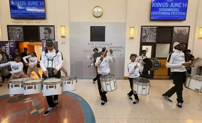 Brooklyn United Marching Band kicks in the Langston Hughes Auditorium celebrating the centennial of the Schomburg Center for Research in Black Culture in New York on Saturday, June 14, 2025. (AP Photo/Jaylen Green)