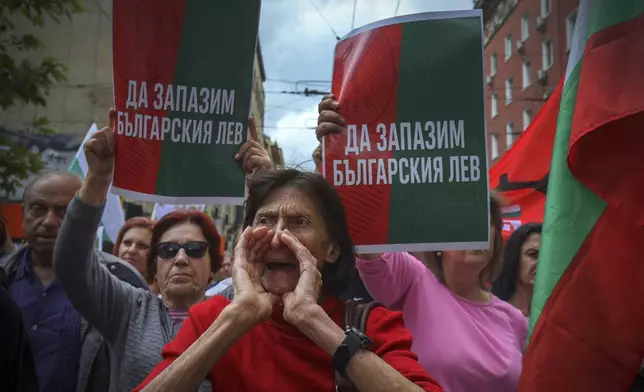 A protester shouts anti-euro slogans in front of signs reading 'Preserve Bulgarian Lev!' during an anti-Euro protest in Sofia, Bulgaria, Saturday 31, May 2025. (AP Photo/Valentina Petrova)