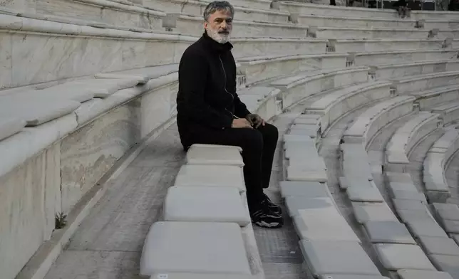 Greek National Opera's Artistic Director, Giorgos Koumendakis poses ahead of the dress rehearsal of Giacomo Puccini's "Turandot" by the Greek National Opera during the 70th Athens Epidaurus Festival in Athens, Greece, Friday, May 30, 2025. (AP Photo/Thanassis Stavrakis)