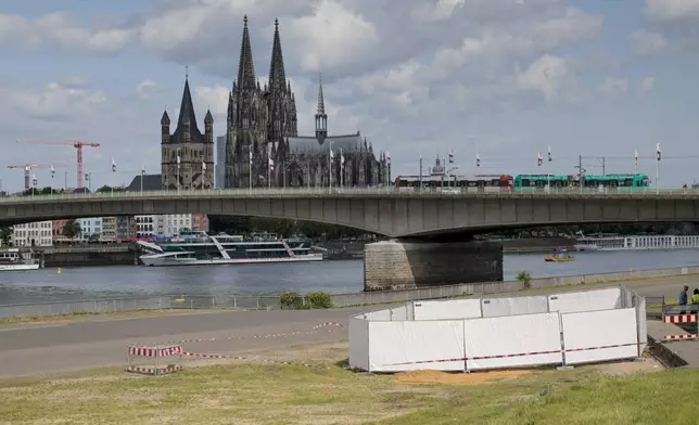 One of the three unexploded bombs from the Second World War is fenced off with screens as specialists prepare to defuse them in Cologne, Tuesday, June 3, 2025. (Thomas Banneyer/dpa via AP)