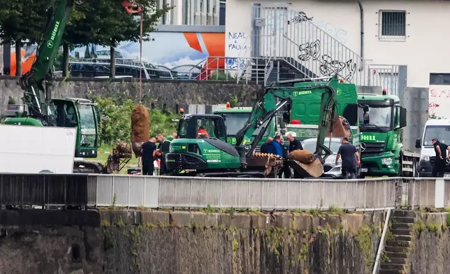 Two of the three unexploded World War II bombs are defused and prepared to be loaded onto vehicles for removal, Wednesday, June 4, 2025, in Cologne, Germany. ( Christoph Reichwein/dpa via AP)
