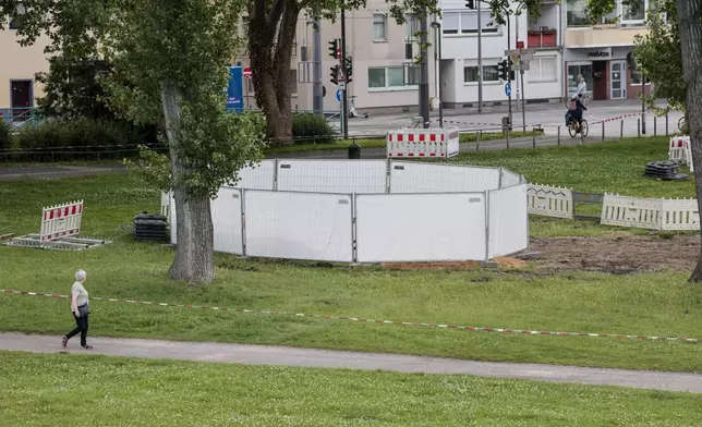 One of the three unexploded bombs from the Second World War is fenced off with screens as specialists prepare to defuse them in Cologne, Tuesday, June 3, 2025. (Thomas Banneyer/dpa via AP)