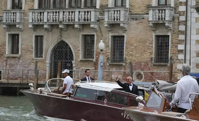 Jeff Bezos waves as he leaves a hotel ahead of the anticipated wedding celebrations with Lauren Sanchez, in Venice, Italy, Friday, June 27, 2025. (AP Photo/Antonio Calanni)