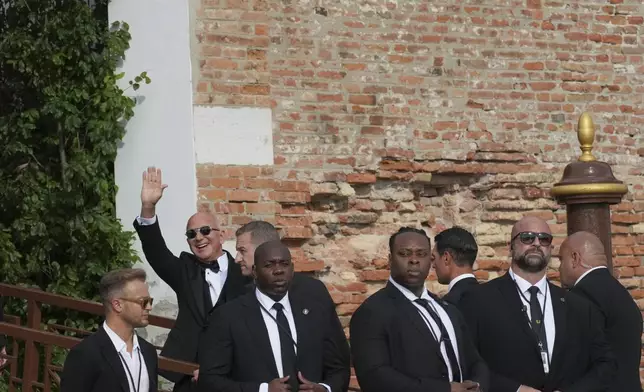 Jeff Bezos waves as he arrives at San Giorgio island ahead of the anticipated wedding celebrations with Lauren Sanchez, in Venice, Italy, Friday, June 27, 2025. (AP Photo/Antonio Calanni)