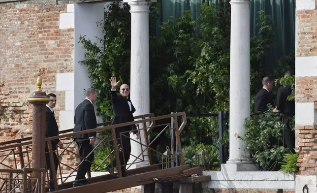 Jeff Bezos waves as he arrives at San Giorgio island ahead of the anticipated wedding celebrations with Lauren Sanchez, in Venice, Italy, Friday, June 27, 2025. (AP Photo/Luigi Costantini)
