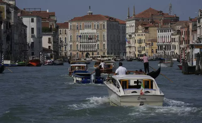 Boats cruise along the Grand Canal in Venice, Italy, on Wednesday, June 25, 2025, ahead of festivities in the lagoon city reportedly linked to a wedding celebration for Jeff Bezos and Lauren Sánchez. (AP Photo/Luca Bruno)