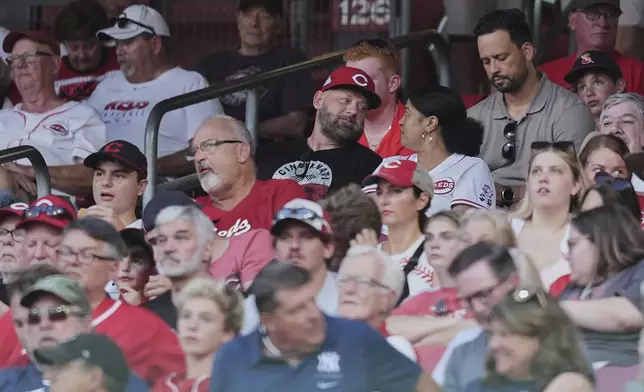 David Burns, center left, and Trinetti Burns, center right, parents of Cincinnati Reds pitcher Chase Burns, sit in the stands during the seventh inning of a baseball game against the New York Yankees, Tuesday, June 24, 2025, in Cincinnati. (AP Photo/Joshua A. Bickel)