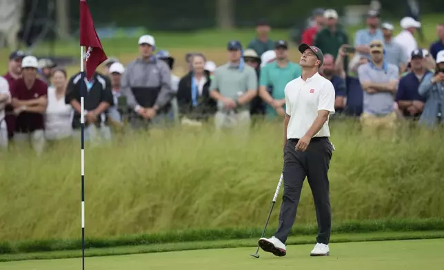 Adam Scott, of Australia, reacts after missing a putt on the 14th hole during the final round of the U.S. Open golf tournament at Oakmont Country Club Sunday, June 15, 2025, in Oakmont, Pa. (AP Photo/Seth Wenig)