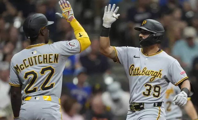Pittsburgh Pirates' Nick Gonzales (39) is congratulated by Andrew McCutchen (22) after hitting a three-run home run during the sixth inning of a baseball game against the Milwaukee Brewers, Tuesday, June 24, 2025, in Milwaukee. (AP Photo/Aaron Gash)