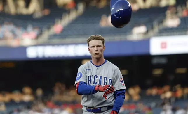 Chicago Cubs' Pete Crow-Armstrong tosses his helmet after striking out against Washington Nationals pitcher MacKenzie Gore during the third inning of a baseball game in Washington, Wednesday, June 4, 2025. (AP Photo/Terrance Williams)