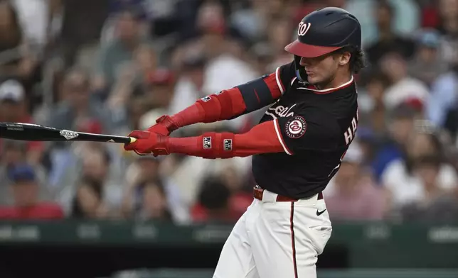 Washington Nationals' Robert Hassell III follows through on his swing after hitting a single against Chicago Cubs pitcher Matthew Boyd during the sixth inning of a baseball game in Washington, Wednesday, June 4, 2025. (AP Photo/Terrance Williams)