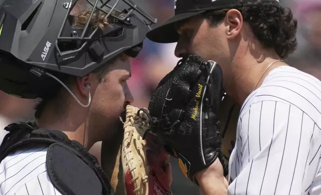 Chicago White Sox catcher Kyle Teel, left, talks with starting pitcher Mike Vasil during the second inning of a baseball game against the Kansas City Royals in Chicago, Sunday, June 8, 2025. (AP Photo/Nam Y. Huh)