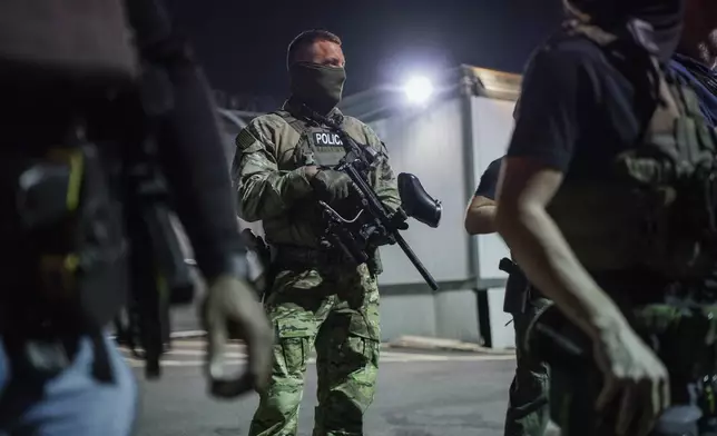 Immigration enforcement agents guard outside the Delaney Hall Detention Facility during a protest over federal immigration enforcement raids on Thursday, June 12, 2025, in Newark, N.J. (AP Photo/Olga Fedorova)