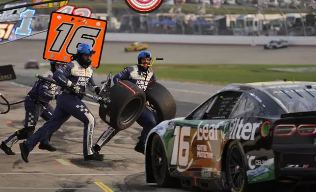 The pit crew for AJ Allmendinger (16) jumps over the wall for a pit stop during a NASCAR Cup Series auto race Sunday, June 1, 2025, in Lebanon, Tenn. (AP Photo/George Walker IV)