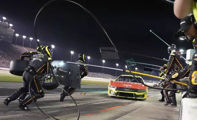 The pit crew for Ryan Blaney rushes to work on the car during a NASCAR Cup Series auto race Sunday, June 1, 2025, in Lebanon, Tenn. (AP Photo/George Walker IV)