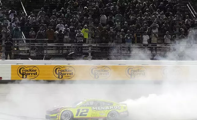 Ryan Blaney does a burnout after winning a NASCAR Cup Series auto race Sunday, June 1, 2025, in Lebanon, Tenn. (AP Photo/George Walker IV)