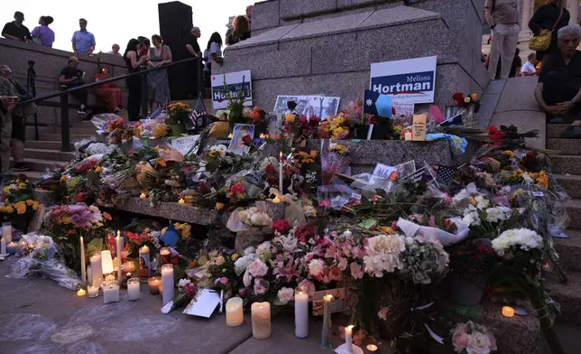 People attend a candlelight vigil for former House Speaker Melissa Hortman and her husband Mark, who were fatally shot, at the state Capitol, Wednesday, June 18, 2025, in St. Paul, Minn. (AP Photo/Nikolas Liepins)